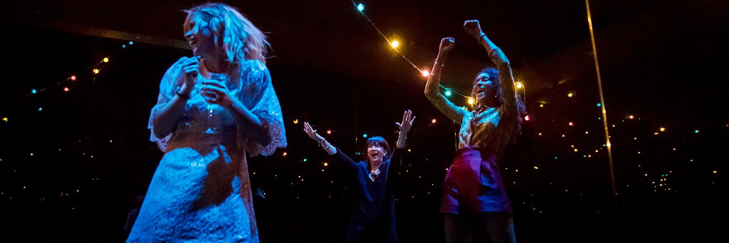 Production photo from Yerma by Johan Persson of the cast partying in the festival scene.