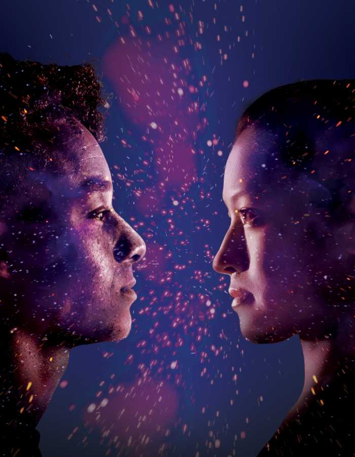 The side profiles of two people looking at each other on a purple background with sparks between them. 