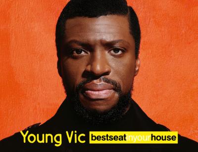 Best Seat in Your House: Mandela. From 19 - 23 Jan 2023. Image description: A man, wearing a dark coat, staring intently at the camera against an orange background. At the bottom of the image are the words, 'Young Vic Best Seat in Your House', in black white and yellow 